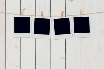 Four blank photo frame hanging on white wood background with spa