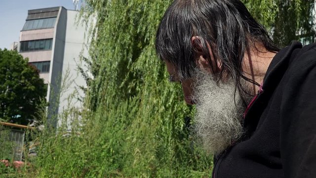 old beggar man in the street: economic crisis, rejected, sadness, loneliness 