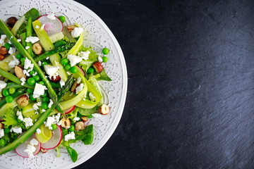 Fresh Green Asparagus salad witch Goat Cheese, peas, radishe, zucchini, lettuce and Hazelnuts.