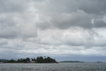High Island with radio transmission tower on a cloudy day - 130096286