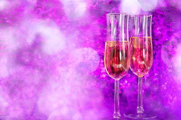 Two champagne glasses on the violet party background