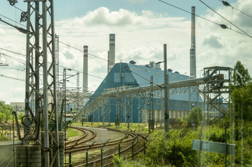 Train tracks passing through an industrial complex