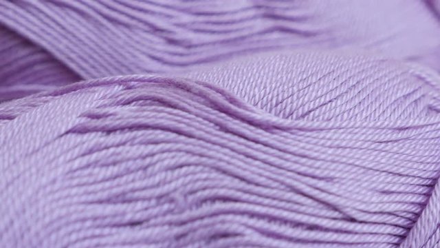Pink yarn of wool wrapped in loose twist close-up 4K 2160p 30fps UltraHD footage - Slow pan on knitting wool skeins shallow DOF 3840X2160 UHD panning video