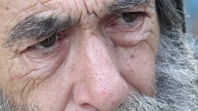 closeup footage on eyes of a real old homeless