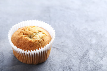 Tasty muffin on a grey wooden table