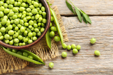 Green peas on a grey wooden table