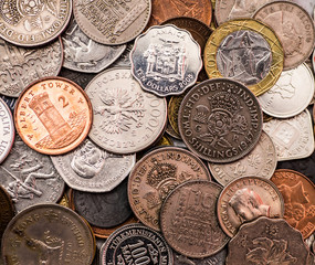 Coins of several currencies - background pattern.