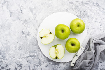 fashionable colors, the green apples on a gray marble table   white cutting board. Top view