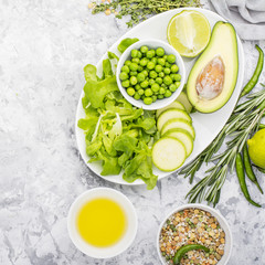 Fresh green vegetables and herbs. Ingredients for the seasonal dishes. The concept of organic natural food. Top view