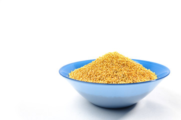 Blue bowl of barley grits isolated on white