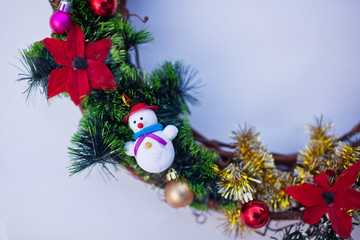 Christmas wreath decorated with fir-tree balls and toys, tinsel