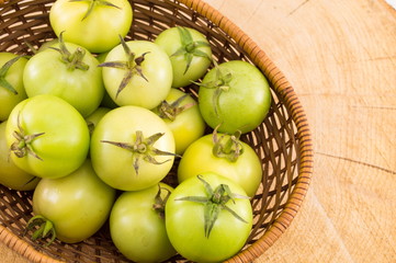 Green tomatoes in a wicker basket