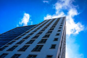 From bottom to top view of modern residential skyscrapers, high-rise buildings with palm trees and swimming pools on their roofs and blue sky, Copacabana district, Rio de Janeiro, Brazil