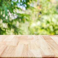 Rubber wood tabletop texture square with blurry nature leaf back