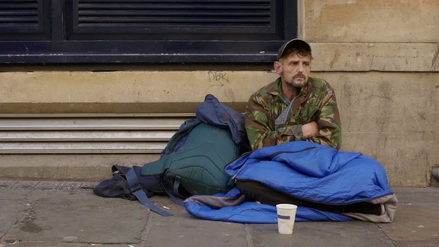 homeless begging in the street: young jobless man 