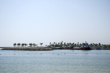 Boat dredger creating land coastline Souly Bay Salalah Oman 2