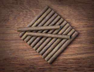 Cigarillo on wooden background