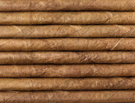 Chocolate cigars in row as background.