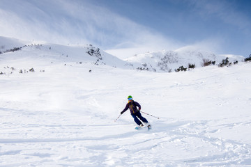 Skier riding on fresh snow in the Carpathian mountains, Ukraine