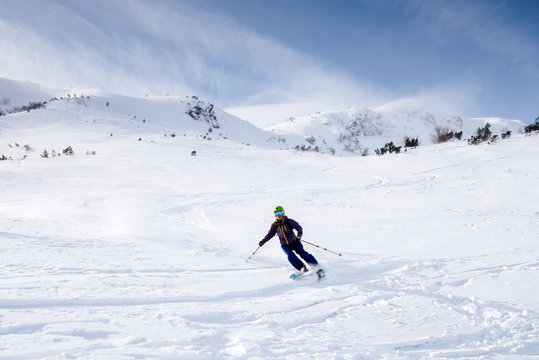 Skier riding on fresh snow in the Carpathian mountains, Ukraine