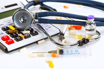 Stethoscope, pills and bottles on color background. medicine con