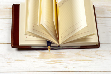 Close-up of open book and pen.