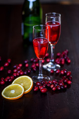 Raspberry Mimosa with blood orange on dark wood background