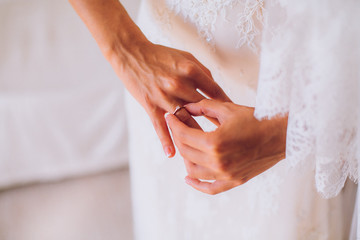 Bride getting ready. Bride dressing gown. bride is getting ready in the morning. Brides maid helps bride dress in wedding dress for wedding day