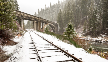 Rail tracks and iconic bridge in winter snow storm