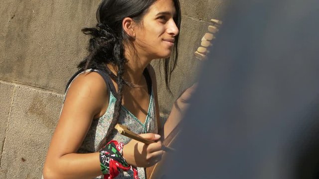 street artist sitting on the sidewalk among the people