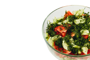 Fresh salad with tomatoes, cucumbers, dill in a bowl on white ba