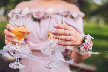 Delighted bridesmaid holding the glass of champagne outdoor