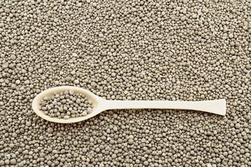 Porcelain laboratory spoon on mineral fertilizers