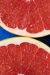 red grapefruit cut in half on a plate