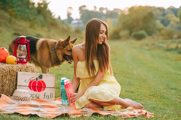 mother and daughter at a picnic with a dog