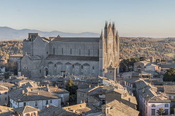 Orvieto Cathedral is surrounded by the old town, seen from the Moro tower - obrazy, fototapety, plakaty