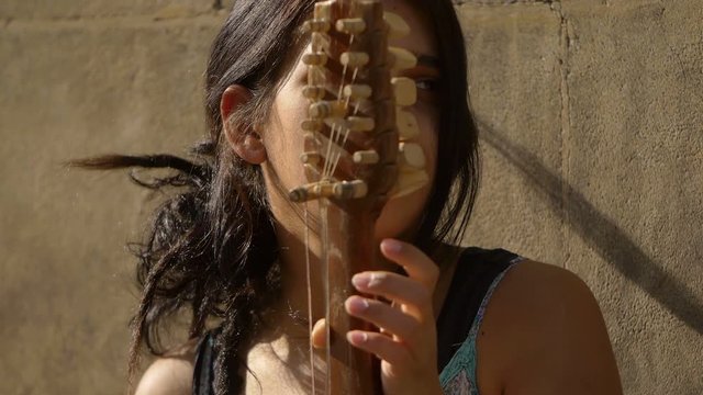 playing the string in the street: young female street artist 