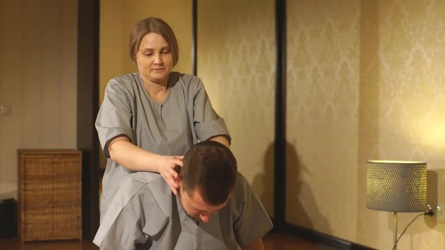 Man getting massage in spa. Female therapist