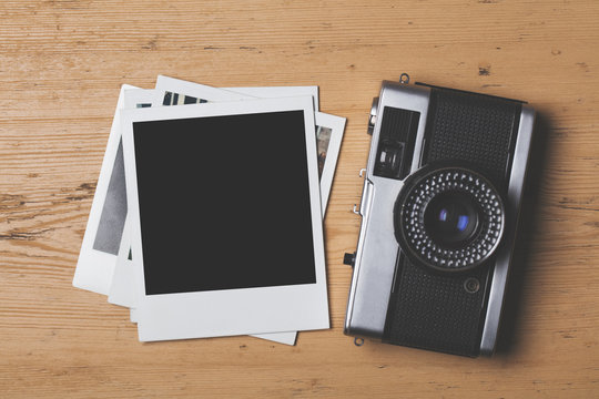 Blank vintage instant photograph with a retro camera