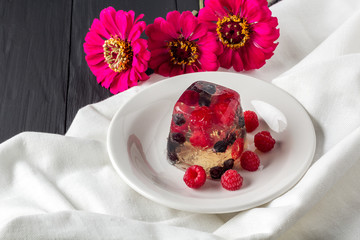 Berry jelly on plate and flowers