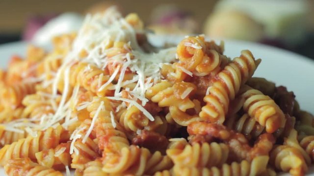 Hot Pasta with tomato Sauce, Parmesan Cheese on a Spoon