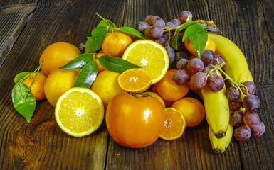 composition of fresh fruits in wicker baskets on a wooden backgr