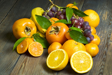composition of fresh fruits in wicker baskets on a wooden background