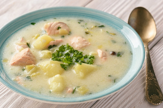 Potato soup with salmon, leek, sour cream and parsley.