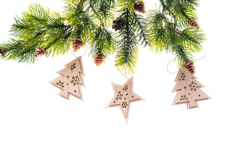 fir branches with cones and wooden toys on white background