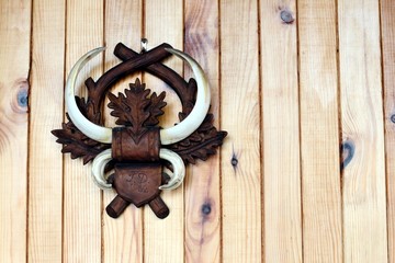 Tusks from wild boar hang on wooden wall