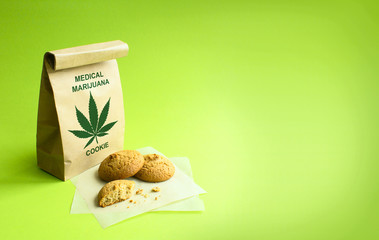 Cookies of medical marijuana in the kraft bag. Green background.