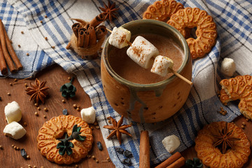 Beautiful ceramic cup with cocoa and marshmallow stands at check