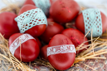 Red Easter eggs in a nest of hay