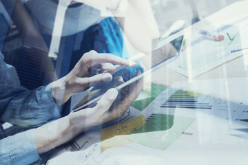 Concept of business woman using mobile devices.Closeup view female hands touching display digital tablet.Double exposure,modern skyscraper office building on blurred background.Horizontal,film effect.